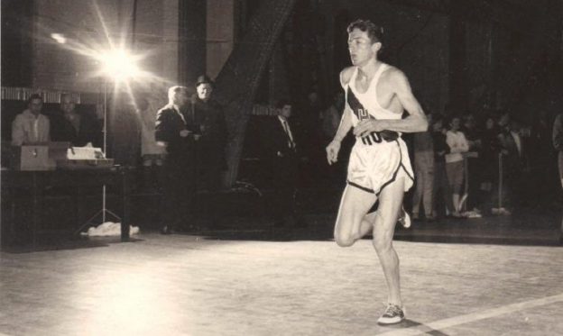 A young Bobby Doyle is running on the street. He's wearing a white track uniform.
